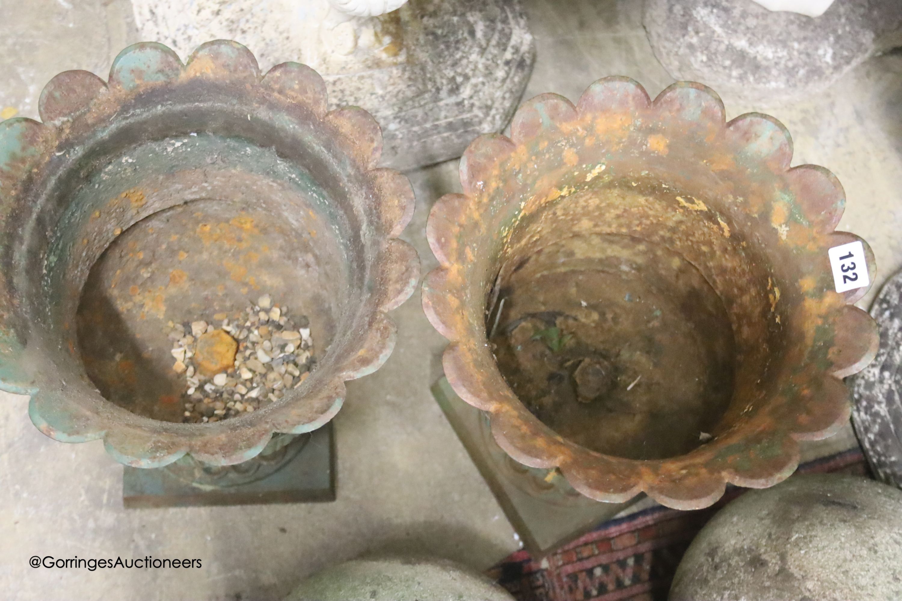 A pair of painted cast-iron garden urns
